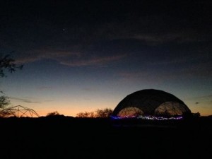 Yoga Dome lit up at night.